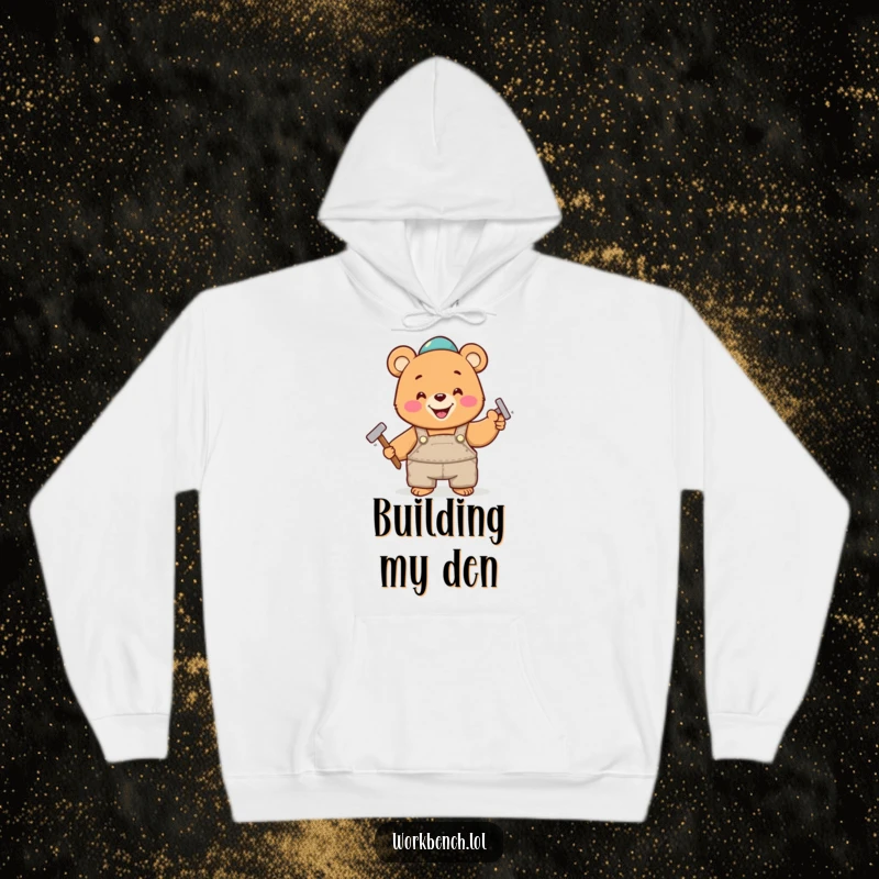 Funny hoodie featuring a joyful bear in overalls, enthusiastically hammering a nail, symbolizing hard work and playful construction.